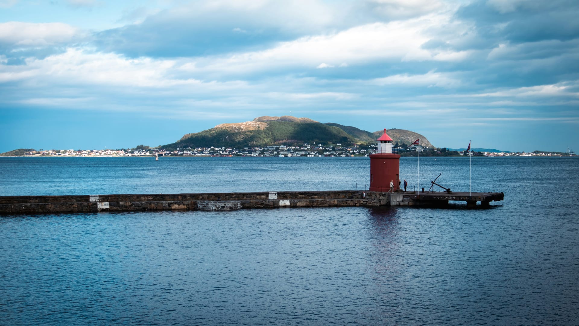 Aker Brygge waterfront district in Oslo, Norway, featuring modern architecture, restaurants, and evening city lights.