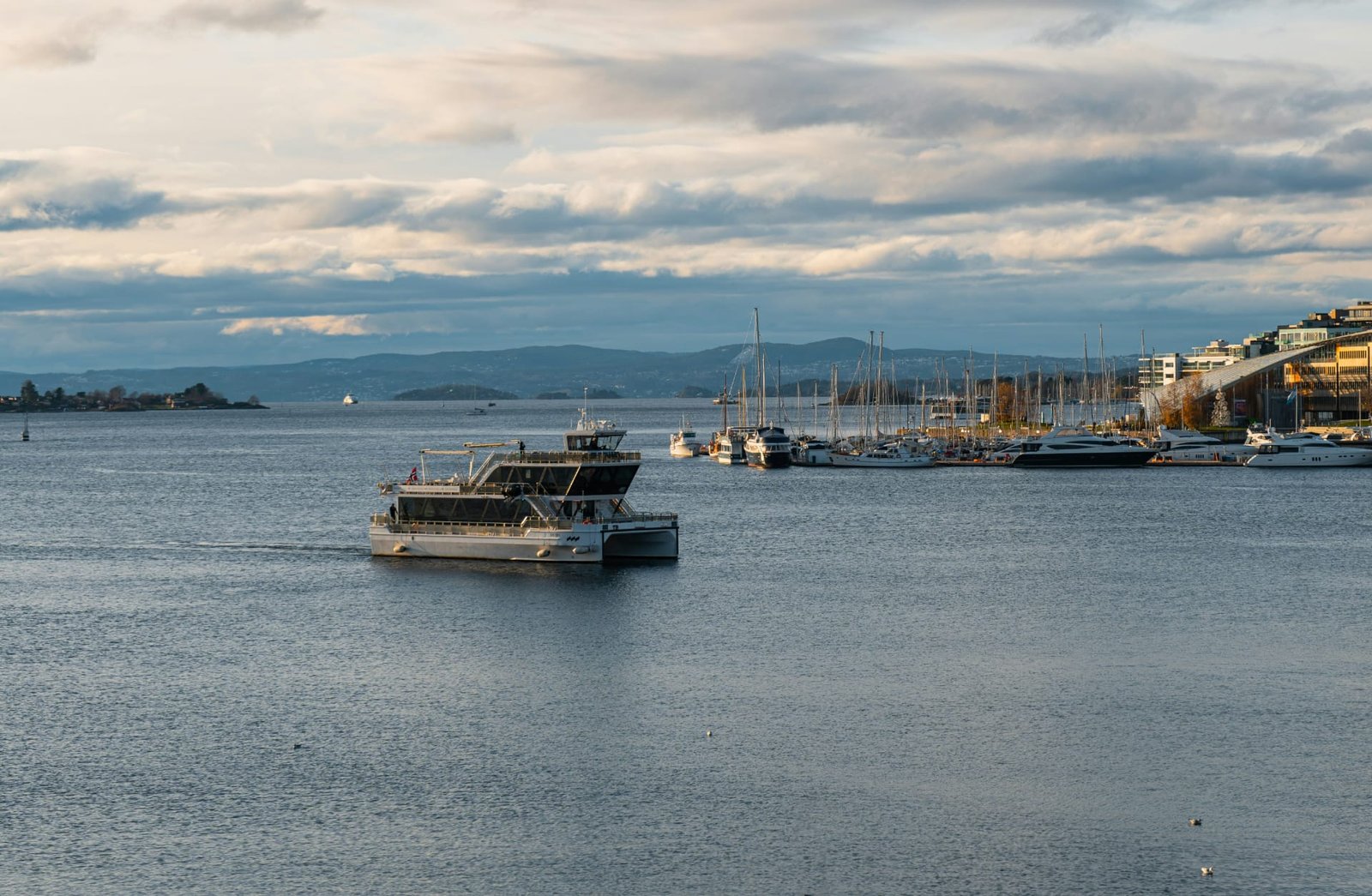 Oslofjord, a harbour filled with lots of boats under a cloudy sky Oslofjord, a harbour filled with lots of boats under a cloudy sky
